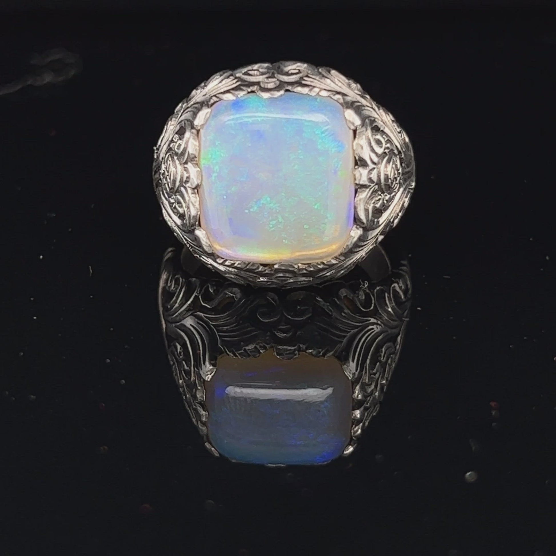 Fantastic one-off silver ring, crafted to show off this awesome Coober Pedy crystal opal. Square cushion cut showing magnificent greens.