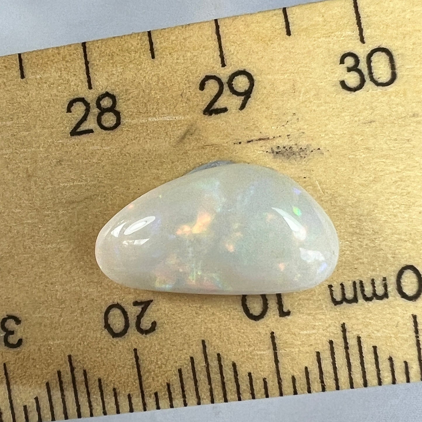 Nice solid white opal from Coober Pedy, displaying rolling flash colours.