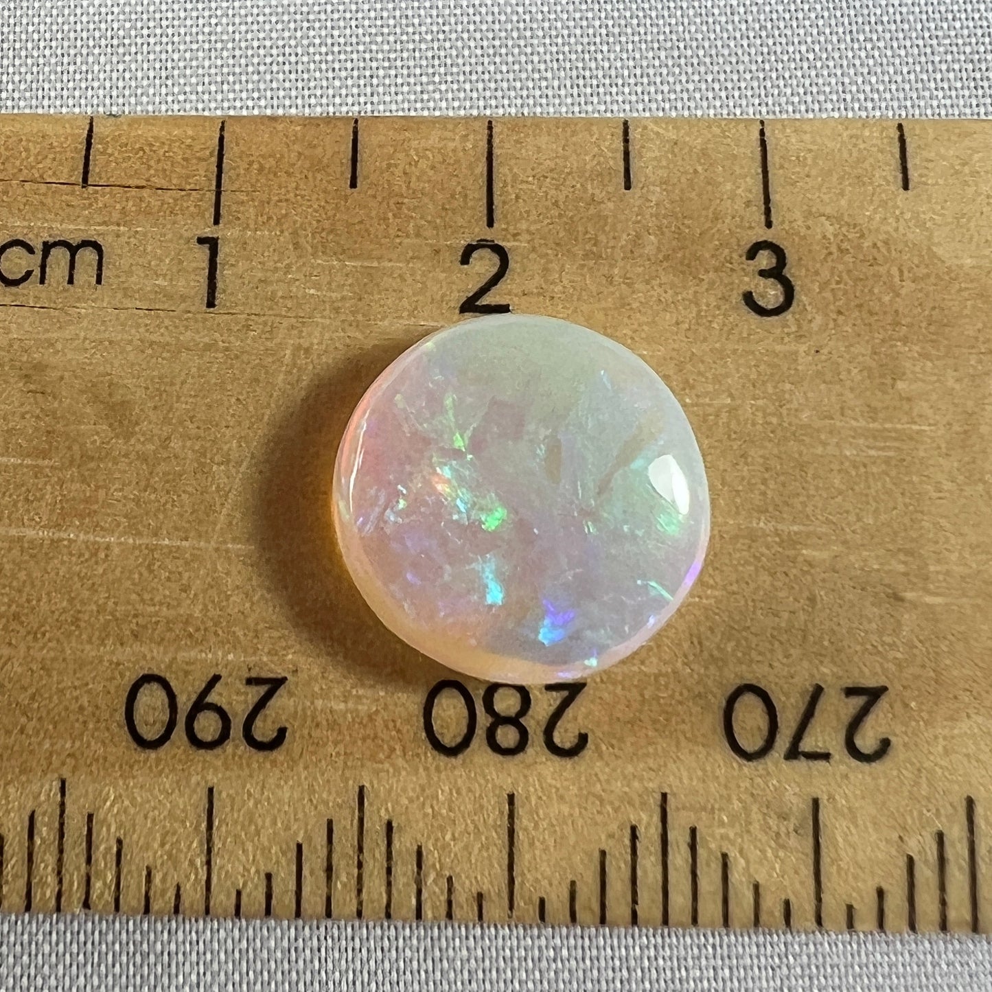 Beautiful round cut Lightning Ridge crystal opal. Polished both sides by Bill Johnston.