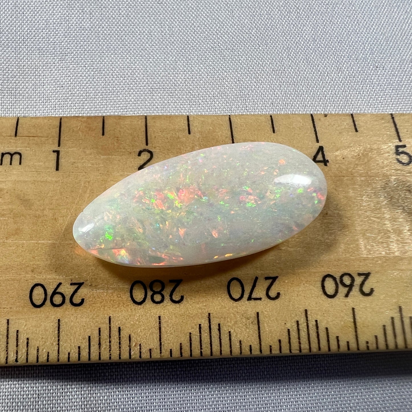 Beautiful 9.1ct Coober Pedy solid white opal. Double sided and showing all the colours. Cut and polished by Bill Johnson.