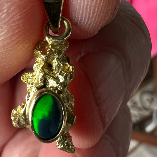 Pure solid gold nugget pendant from Western Australia. Perfectly set with a 18ct gold bale. Set beautifully with a solid black opal from Lightning Ridge.