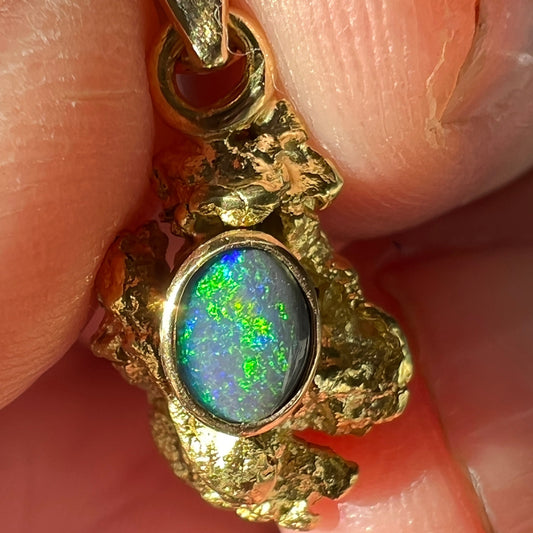 Pure gold nugget pendant from Western Australia. Perfectly set and balanced with an 18ct bale. Set with a perfectly cut solid black opal from Lightning Ridge.