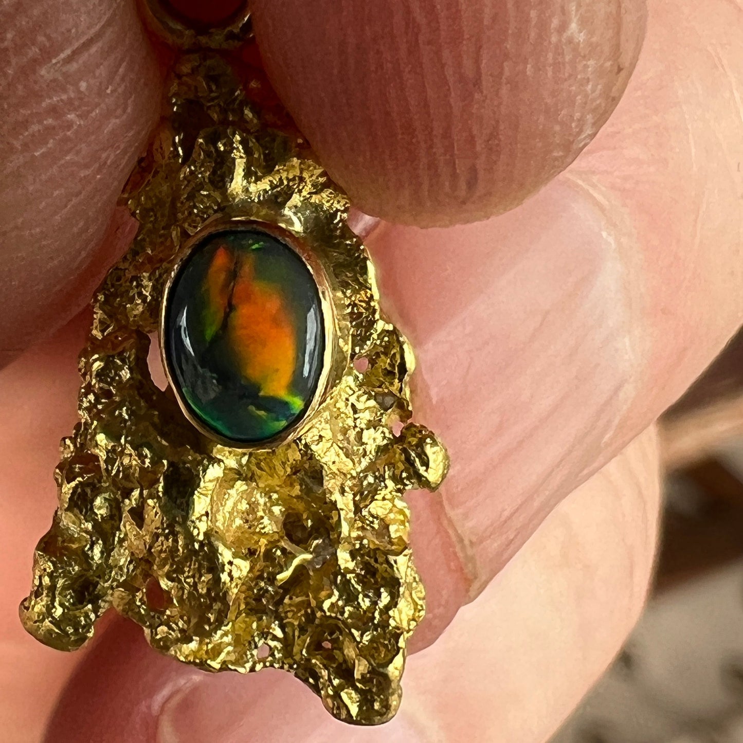 Pure solid gold nugget pendant from Western Australia. Perfectly set and balanced with an 18ct bale. Set with a beautifully cut black opal from Lightning Ridge.