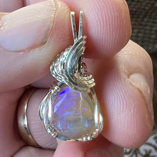 Beautifully cut Lightning Ridge Jelly Crystal opal. Cut and polished by Bill Johnson. Expertly set in a unique silver wire wrap. An awesome hand made gift.