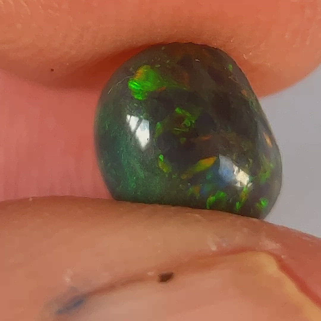 Beautiful round semi black Lightning Ridge opal. An awesome ring stone.