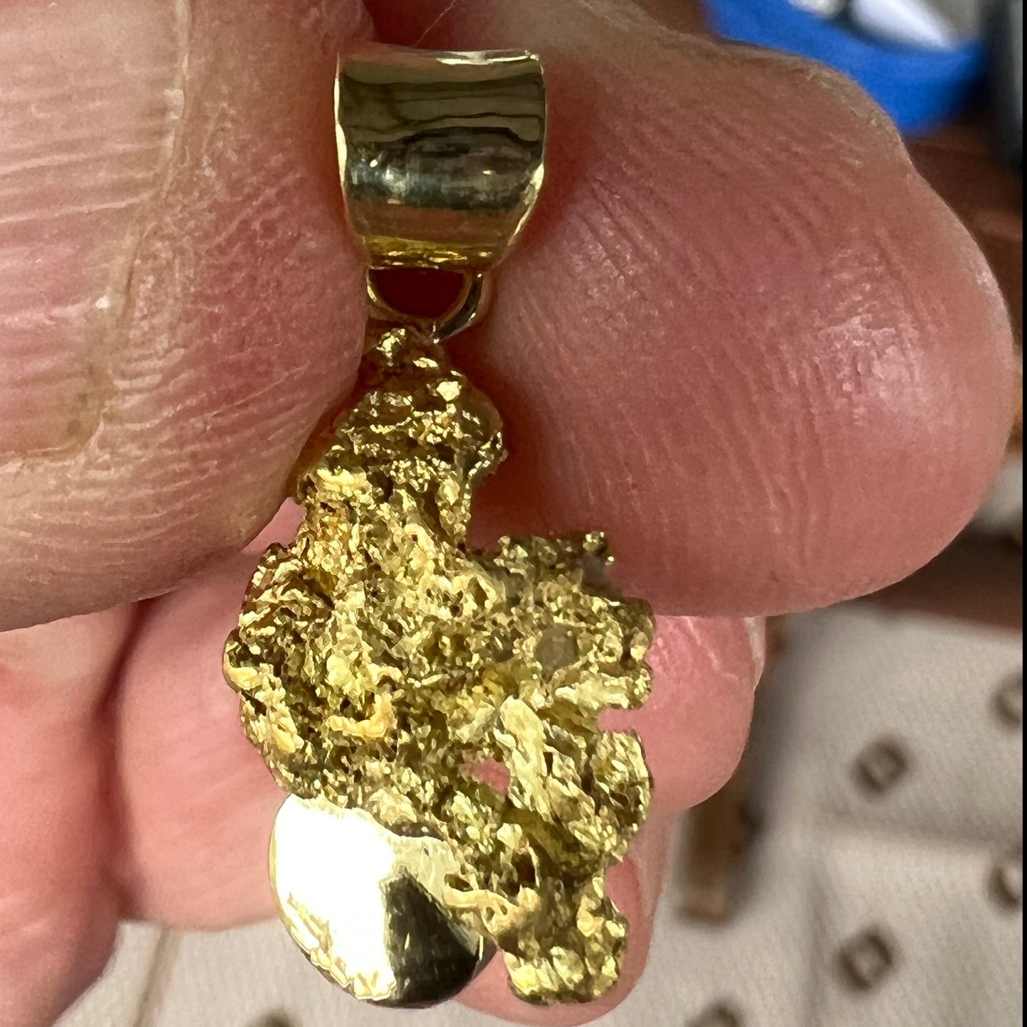 Pure solid gold nugget pendant from Western Australia. Perfectly set with an 18ct bale. Set with a beautifully cut black opal from Lightning Ridge.