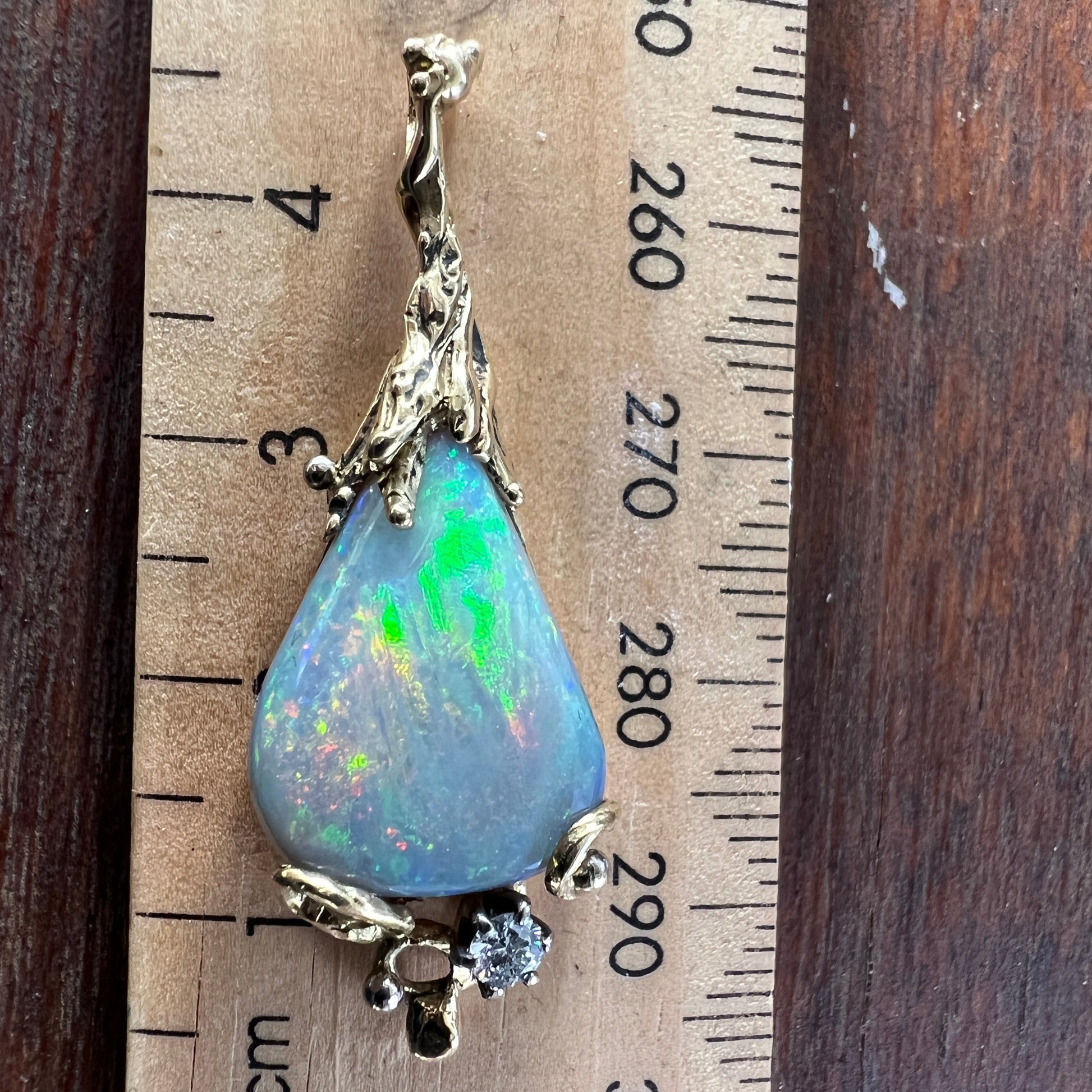 Stunning pendant hand made by Sally Fisher. Beautiful 8.5ct Lightning Ridge black opal mined 25-30 metres below what is now the 'Black Opal Motel'. Moulded 18ct gold  finished off with a brilliant cut diamond.  A masterpiece.